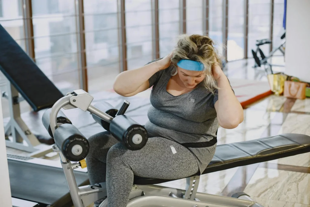 A woman working out on gym equipment, promoting fitness and a healthy lifestyle.